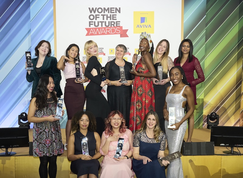 Award winners holding trophies at an awards event